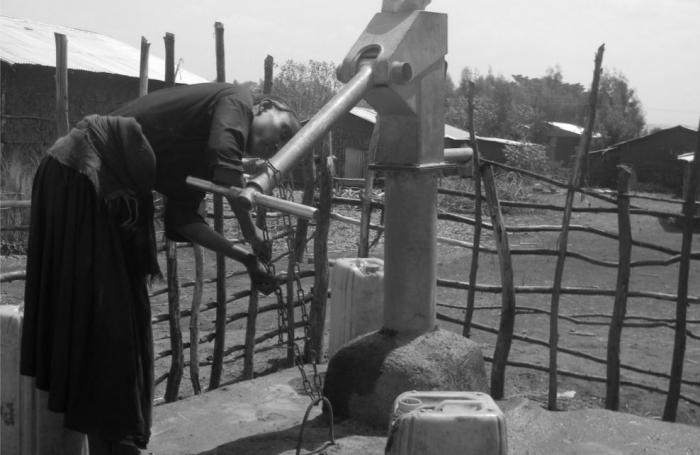 Women next to hand pump in Ethiopia