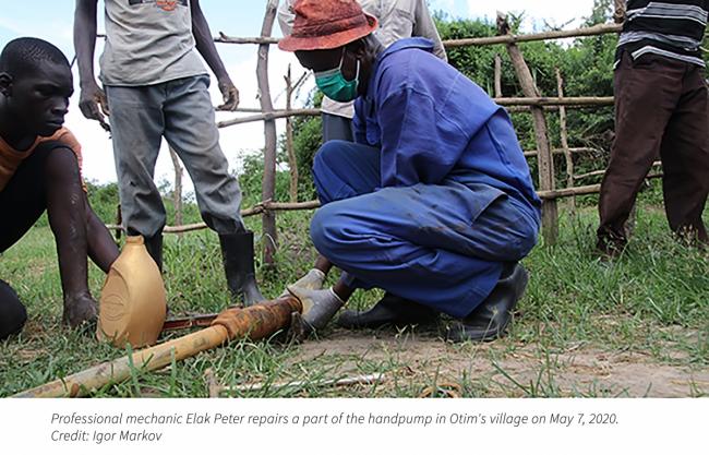 Professional mechanic Elok Peter repairs a part of the handpump in Otim's village on May 7, 2020