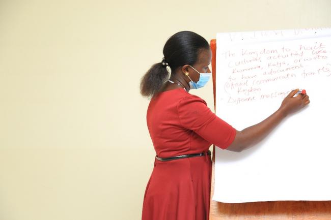 Monica Komucunguzi from Caritas HEWASA facilitates at the strategic meeting with cultural leaders